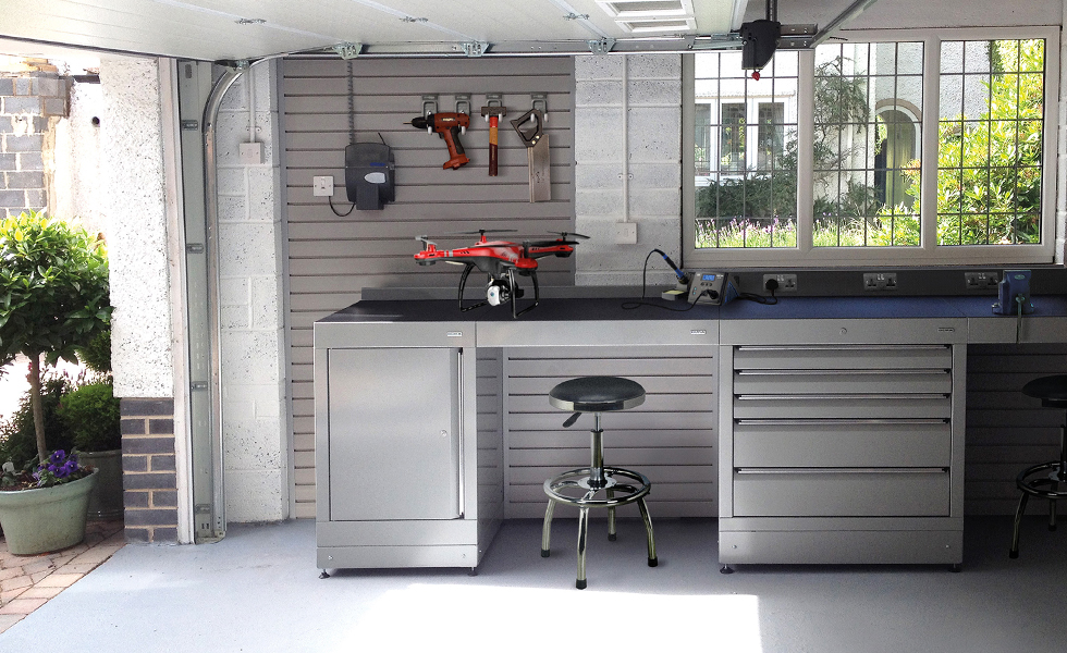 Dura home garage workshop with low level cabinets and StorePanel wall storage