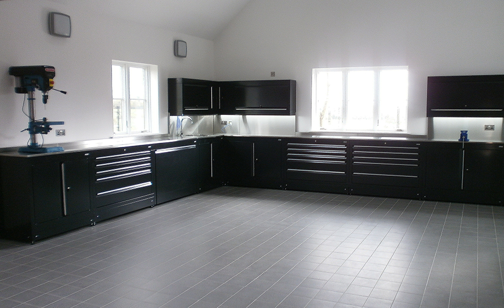 Extensive home workshop area with modular Dura cabinets and porcelain floor tiles